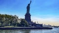 The lady of New York (USA) seen from behind and a boat, is how the statue of liberty of the Big Apple is known. Royalty Free Stock Photo