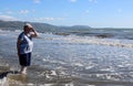 Lady paddling in and looking out to Pacific Ocean Royalty Free Stock Photo