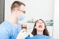 Lady patient at dentist ready to make anesthetic shot Royalty Free Stock Photo