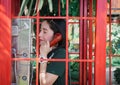 Lady phone in red public telephone booth Royalty Free Stock Photo