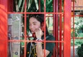 Lady phone in red public telephone booth Royalty Free Stock Photo