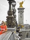 Lady posing on the bridge Pont Alexandre III in Paris