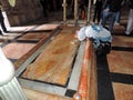 Lady praying at the Stone of Anointing at Church of the Holy Sepulchre, Jerusalem