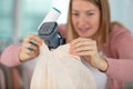 lady preparing garment to remove any fluff