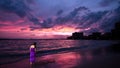 Lady in purple walking on Waikiki Beach, Hawai Royalty Free Stock Photo