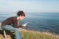 Lady reading a book at the seaside Royalty Free Stock Photo