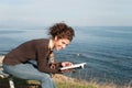 Lady reading a book at the seaside Royalty Free Stock Photo