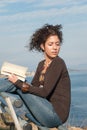 Lady reading a book at the seaside Royalty Free Stock Photo