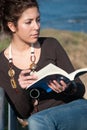 Lady reading a book at the seaside Royalty Free Stock Photo