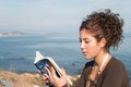 Lady reading a book at the seaside Royalty Free Stock Photo
