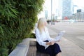Lady reading newspaper outdoors in with close up face. Royalty Free Stock Photo