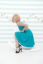 Lady red or ginger wig blue dress rides rocking horse. Comic and humorous concept. Woman playful cheerful mood having Royalty Free Stock Photo