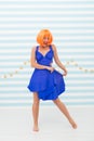 Lady red or ginger wig posing in blue dress. Comic and humorous concept. Woman playful mood having fun. Fun and