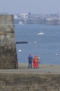 The lady in red and his two friends watching the harbor