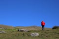 Lady in red jacket walking, hillside path, Cumbria