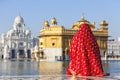 Lady in red sari at the Golden Temple. Royalty Free Stock Photo