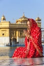 Lady in red sari at the Golden Temple. Royalty Free Stock Photo