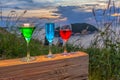 A lady relax on the hilltop with some drink drinks on hill top in front of wind turbine view point