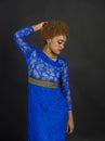 Lady on relaxed face with makeup and afro hairstyle. Lady in dress made out of lace. Woman with african appearance in