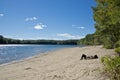 A lady relaxing on the beach at Walden Pond, Massachusetts. Royalty Free Stock Photo