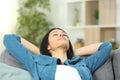 Lady resting sitting on a sofa at home