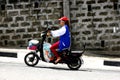 A lady rides her e-bike or electronic bike on an uphill road in Antipolo City.