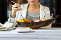 Lady's hand with chopsticks.