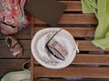 A lady`s summer hat, sunglasses, a book and a light green cotton towel lie on a wooden sunbed on a Sunny summer day on the beach w Royalty Free Stock Photo