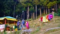 Lady selecting Kimono from colourful collection in a traditional nepalese and bhutanese dress rental shop in India