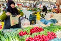 Lady selling fresh vegetables at the market