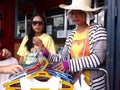A lady sells assorted colorful children's clothes