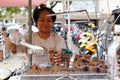 A lady sells deep fried pork liver in her street food cart