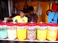 A lady sells a variety of cold refreshments.