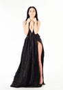 Lady, girl in dress. Woman in elegant black long evening dress with decollete, white background. Fashion dress