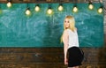 Lady teacher in short skirt looking back while explaining formula. teacher concept. Teacher of mathematics Royalty Free Stock Photo