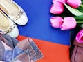 Ballet flat lady shoes and purple bag on yellow and blue background Royalty Free Stock Photo