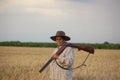 Lady with shootgun ready for hunt in grain field Royalty Free Stock Photo