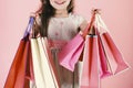 Lady shopper in dress, wavy hair. Girl holds shopping bags