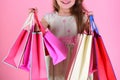 Lady shopper in dress, wavy hair. Girl holds shopping bags