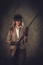 Lady with shotgun and hat from wild west on dark background. Royalty Free Stock Photo