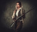 Lady with shotgun and hat from wild west on dark background. Royalty Free Stock Photo