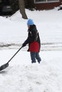 Lady Shoveling Snow from Driveway Royalty Free Stock Photo