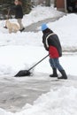 Lady Shoveling Snow from Driveway Royalty Free Stock Photo