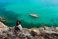 Lady is siiting on a stone on high with laptop Royalty Free Stock Photo