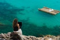 Lady is siiting on a stone on high with laptop Royalty Free Stock Photo