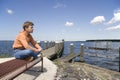 Lady sits on a bench in the Eemmeer Spakenburg - Bunschoten Royalty Free Stock Photo