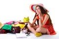 Lady sits beside overfilled suitcase. Royalty Free Stock Photo