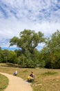 A lady sitting down the bench, Hampstead Heath, UK