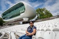 A lady sitting on the empty pavilion of Lord`s Cricket Ground with the media center in