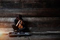 The lady is sitting on grunge surface cement floor,hold violin and bow in her arms,turn face down to volin,vintage and art style